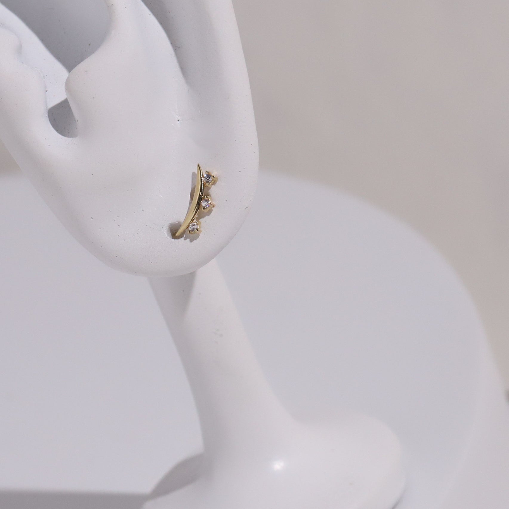 10K Gold Curve Shape with 3 Cubic Studs