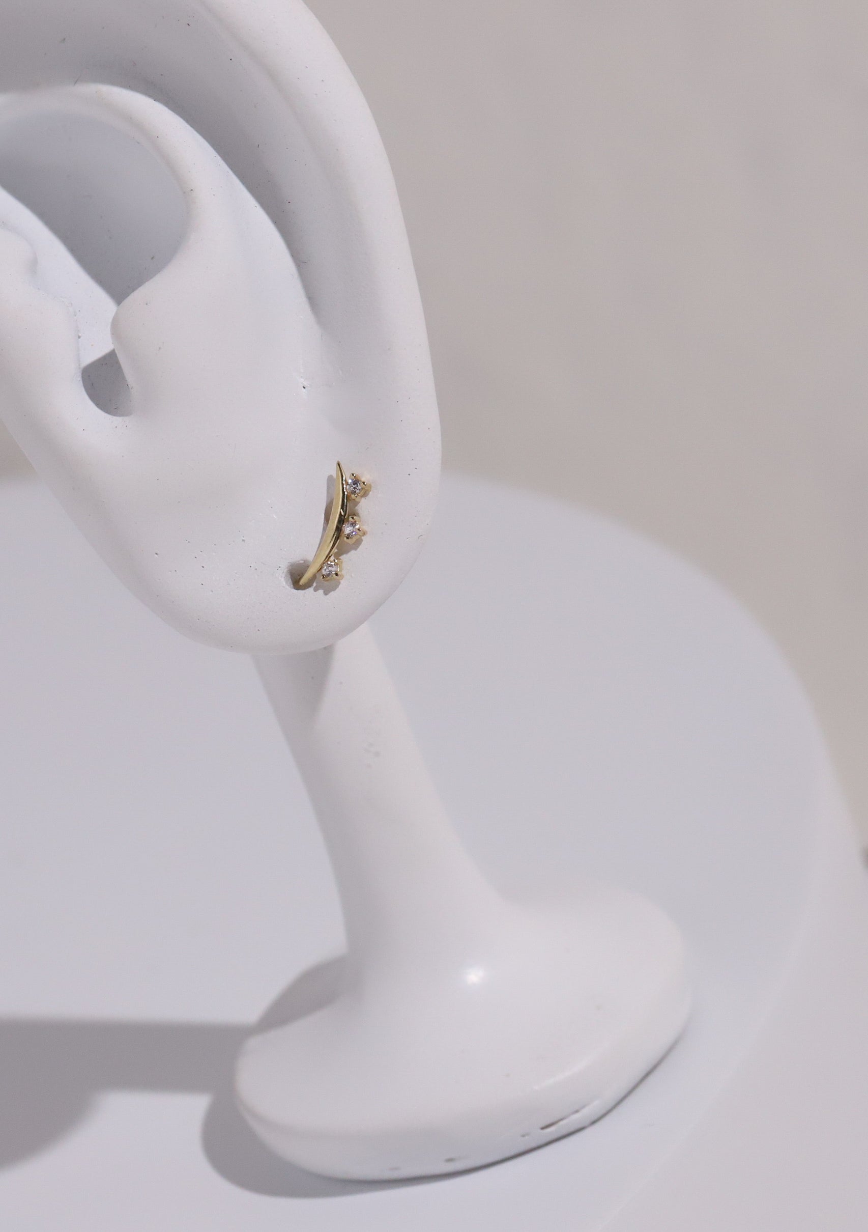 10K Gold Curve Shape with 3 Cubic Studs